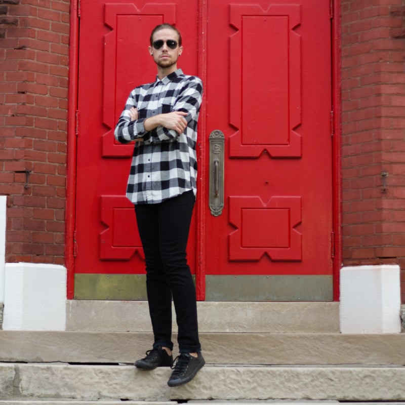 The Kentucky Gent, a men's life and style blogger, in Salt Valley Plaid Shirt, Ray-Ban Aviator Sunglasses from East Dane, Levi's 511 Skinny Jeans, and Converse Chuck Taylors. 