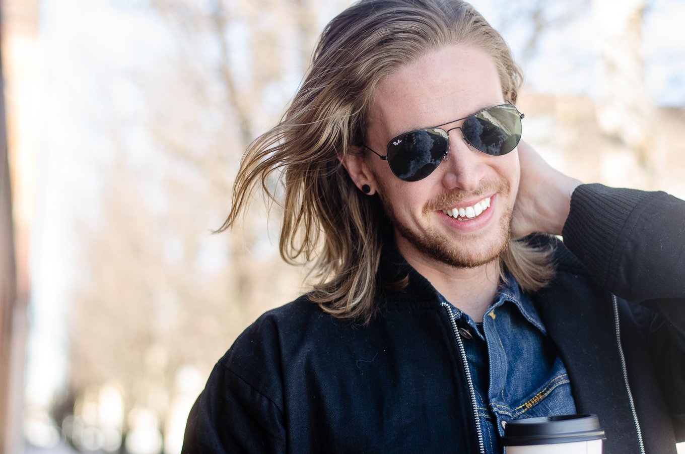 The Kentucky Gent, a men's fashion and lifestyle blogger, whips his hair back and forth. 